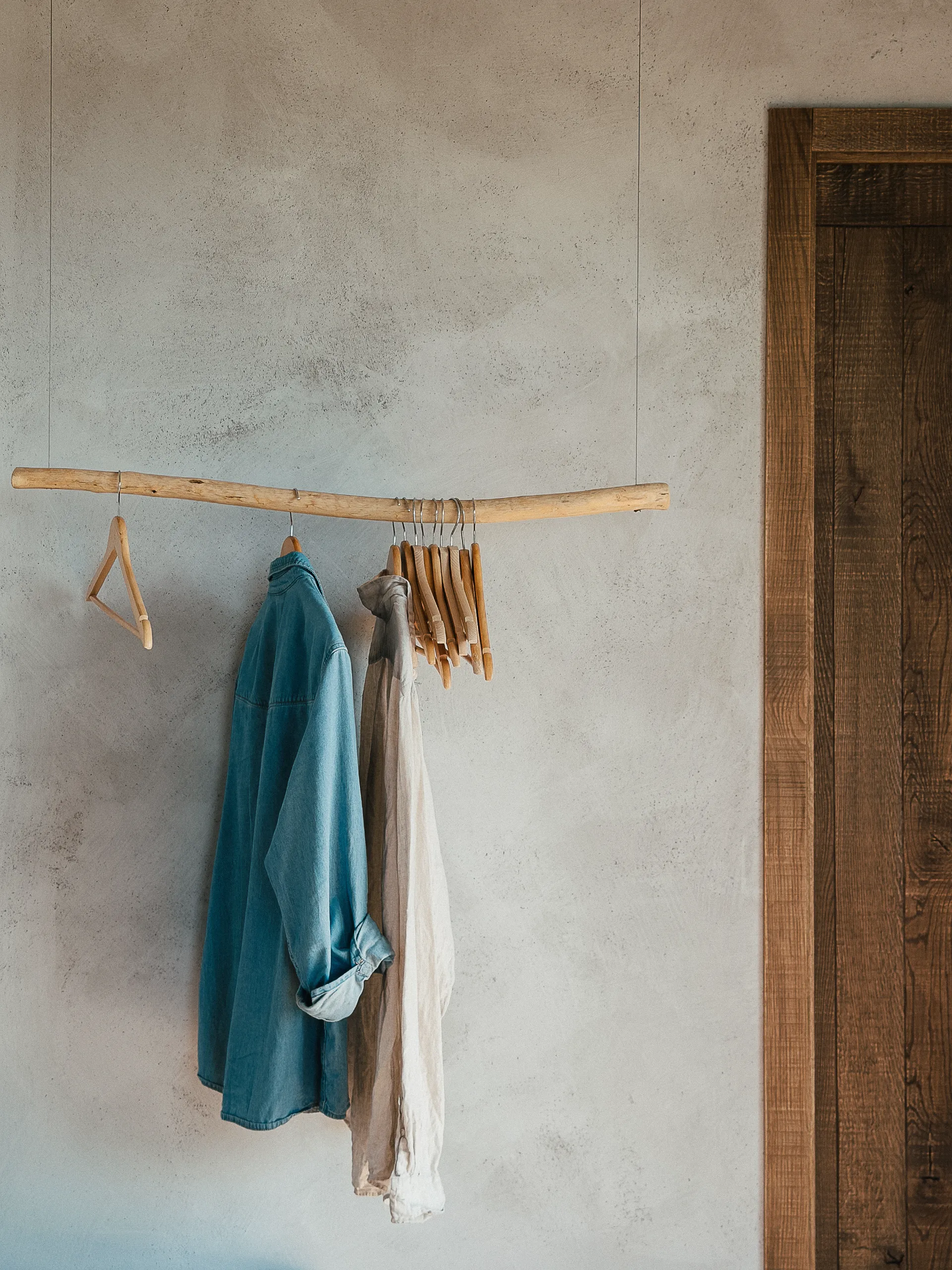 The bedroom's apple-wood clothes rail, in warm colours